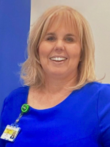 Image is of our trustee Gill Nolan, a woman with blonde shoulder length hair with a fringe wearing a cobalt blue top. She's smiling at the camera.